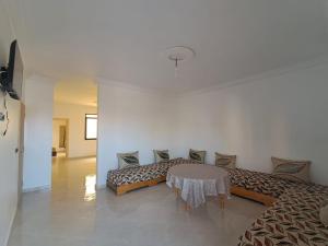 a living room with a couch and a table at Résidence Maya 1 près de la plage in Ras El Ma