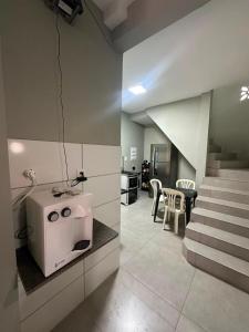 a kitchen with a white stove and a staircase at Center in Uberlândia