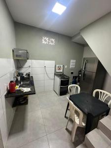 a small kitchen with a table and a table and chairs at Center in Uberlândia