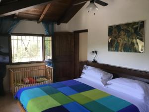 a bedroom with a bed with a colorful blanket at Locanda del Ponte B&B in Balsorano Vecchio