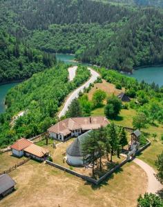 an aerial view of a house on a hill next to a river at Meandri Ćehotine in Pljevlja
