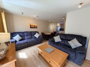 a living room with a couch and a table at The Galleries No 3 in Spean Bridge