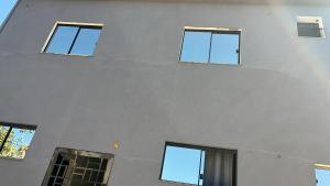 a building with four windows on the side of it at Center in Uberlândia +1 photo