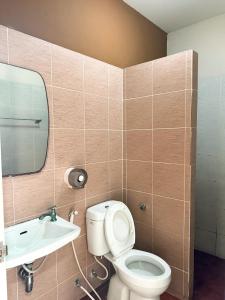 a bathroom with a toilet and a sink at Ratchanee Place in Chaiyaphum