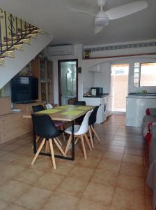 a kitchen and dining room with a table and chairs at villaislandia in Oropesa del Mar +31 photos