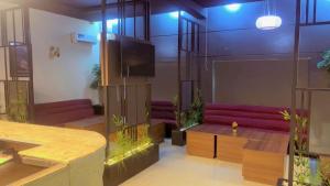 a room with purple couches and a fish tank at Emirates Star Hotel & Suites in Asaba