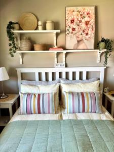 a bedroom with a bed with two pillows at Home between flights Gardermoen in Jessheim