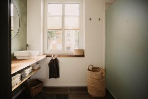 a bathroom with a sink and a window at Villa Medicus in Dessau