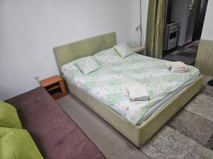 a bed with two towels on it in a room at New apartment Old town 2 in Sarajevo