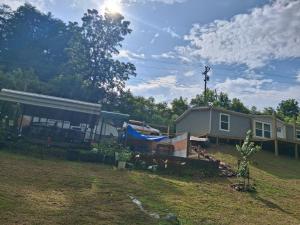 a house and a yard with a house at Camper with Queen and bunk bed in Robbinsville