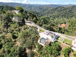 an aerial view of a house in the forest at Casa Brisa with Heated Pool Mountain View & River in Las Marias