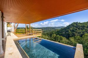 a swimming pool with a view of the mountains at Casa Brisa with Heated Pool Mountain View & River in Las Marias