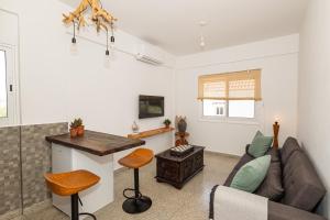 a living room with a couch and a table at Olive Grove Apartments in Larnaca