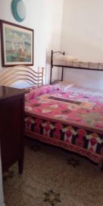 a bedroom with a bed and a dresser and a bed sidx sidx at Il fortino affittacamere in Porto Santo Stefano +13 photos