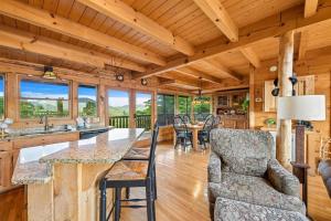 a kitchen and living room with a table and chairs at Above It All #38 by Venture Smoky Mountains in Sevierville