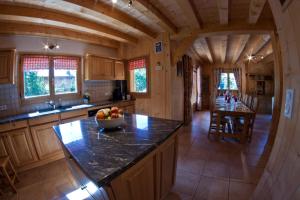 a large kitchen with a counter top in a cabin at Riders Refuge - Chalet Eterle in Morzine