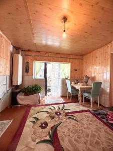 a living room with a table and a dining room at NURDAN Guest House Barskoon in Barskoon