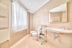 a bathroom with a sink and a toilet and a mirror at Ver Venir, acogedoras habitaciones con piscina in Garínoain +25 photos
