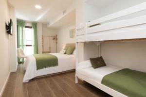 two beds in a room with a bunk bed at Xena Abeto by BeValle in Panticosa