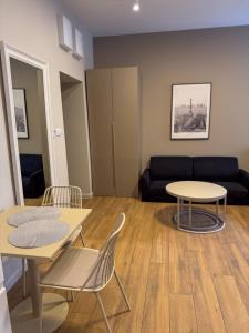 a living room with two tables and a couch at Furman's Court in Lublin
