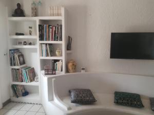 a living room with a bath tub with books at Maison tarnos in Tarnos