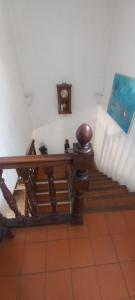 a room with a table and a clock on the wall at Maison tarnos in Tarnos
