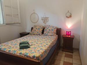 a bedroom with a bed with a bag on it at Maison tarnos in Tarnos