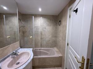 a bathroom with a sink and a bath tub at Gilarez in Estepona