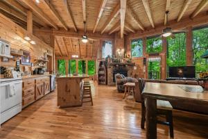 a large kitchen with wooden flooring and a living room at Amazing Grace #25 by Venture Smoky Mountains in Sevierville