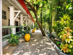 a walkway with vases on the side of a building at Hebron Gardens House in Kandy +91 photos