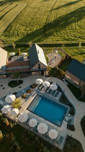 an aerial view of a swimming pool in front of a house at Agrad Chalets in Aschau im Chiemgau