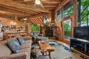 a living room with a couch and a tv and a fireplace at Amazing Grace #25 by Venture Smoky Mountains in Sevierville
