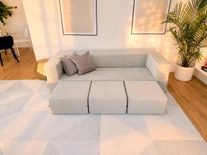 a white couch sitting in a living room at Tropical Luxe Villa-Near Airport, Minutes to Lido key beach, Downtown and Dining in Sarasota