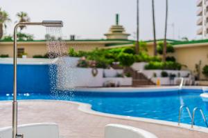 a swimming pool with a water fountain at Paraiso Terrace Suite in Playa Paraiso