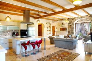 a kitchen and living room with red stools at Villa Mandarin by Important Group Travel in Bitez