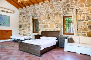 a bedroom with a bed and a stone wall at Villa Mandarin by Important Group Travel in Bitez +58 photos