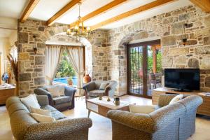 a large living room with a stone wall at Villa Mandarin by Important Group Travel in Bitez