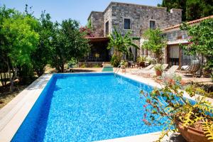 a swimming pool in front of a house at Villa Mandarin by Important Group Travel in Bitez