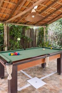 a pool table in a backyard with a pool at Pousada Sítio Xodó in Santana do Riacho