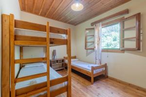 a bunk bed room with two bunk beds and a window at Zanteva-Cottages in Vasilikos
