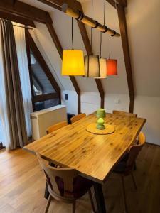 a dining room with a wooden table and chairs at Ferienhaus Amrhein in Siegsdorf