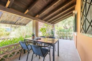 a patio with a table and chairs on a balcony at Zanteva-Cottages in Vasilikos +100 photos