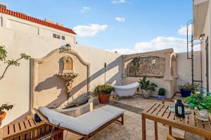 a patio with a tub and a chair on a building at Casa Lucienne in San Juan