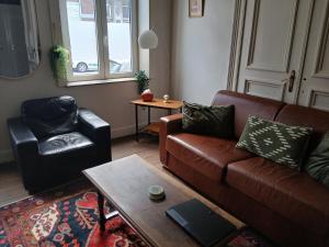 a living room with a couch and a coffee table at Urban Maghin in Liège