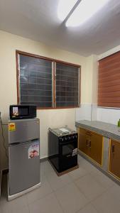 a kitchen with a refrigerator and a stove at Affar homes in Kumasi