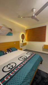 a bedroom with a bed with a comforter on it at Affar homes in Kumasi