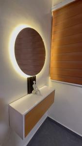 a room with a white table with a round mirror at Affar homes in Kumasi