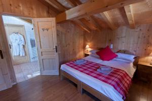 a bedroom with a bed in a room with wooden walls at Riders Refuge - Chalet Eterle in Morzine