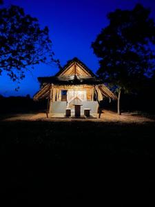 a small hut with a table in front of it at Foresta Yala in Tissamaharama