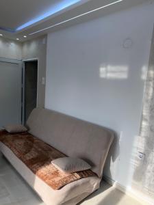 a large bed in the corner of a room at melvina LUX in Pančevo